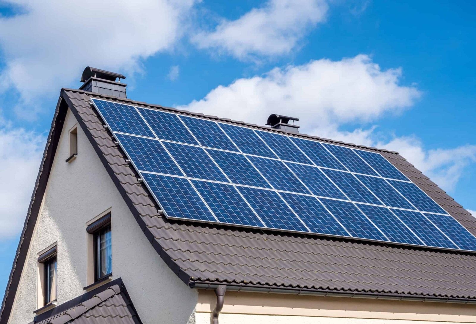 who-are-we-02 white-home-scallop-roof-and-solar-panels-shutterstock-1336991930-scaled-1-scaled